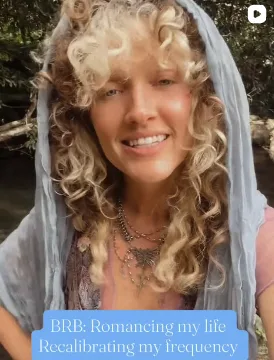 Teddi smiling in a blue veil